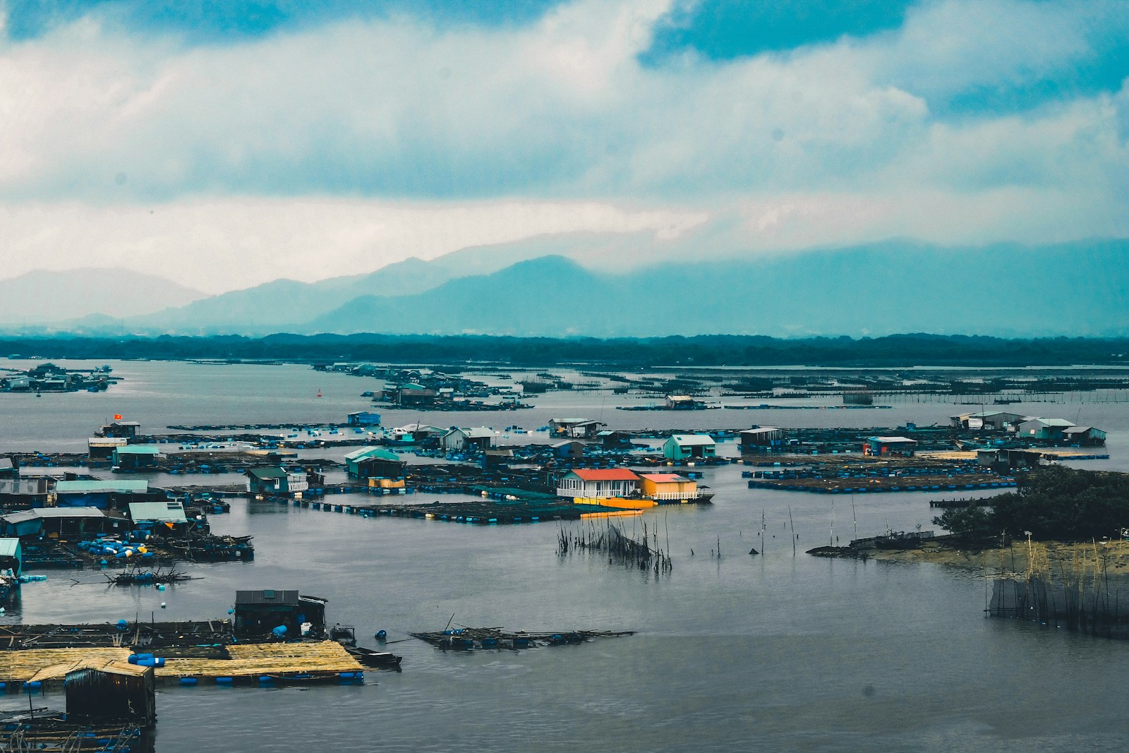 Photo by Nguyen Kiet houses surrounded with water under cloudy sky