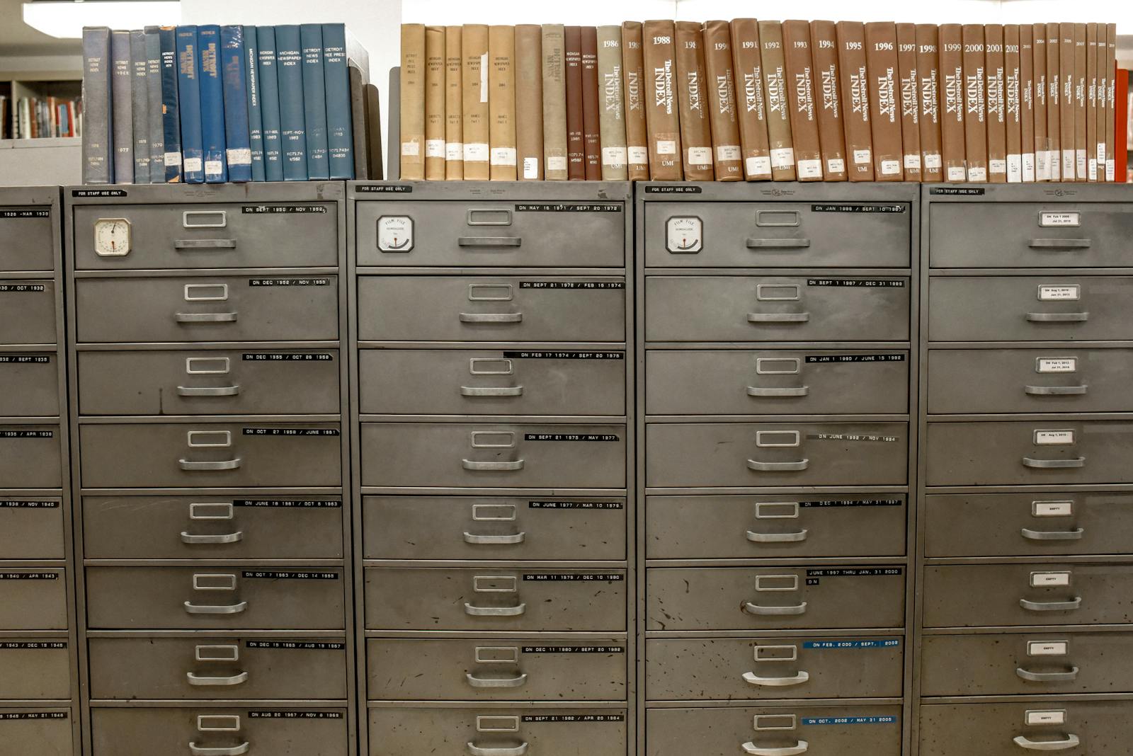 Photo by Element5 Digital Organized filing cabinets stacked with indexed books in a library setting.