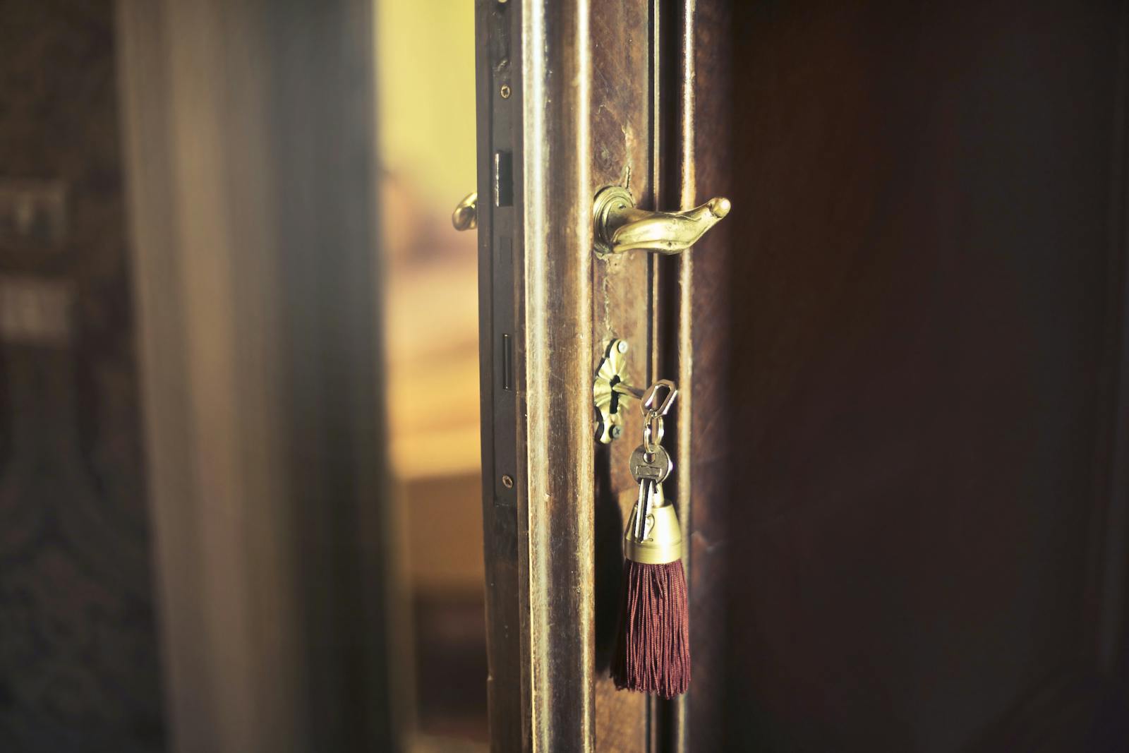Photo by Andrea Piacquadio Close-up of a vintage door with an antique key and tassel, highlighting a rustic design.