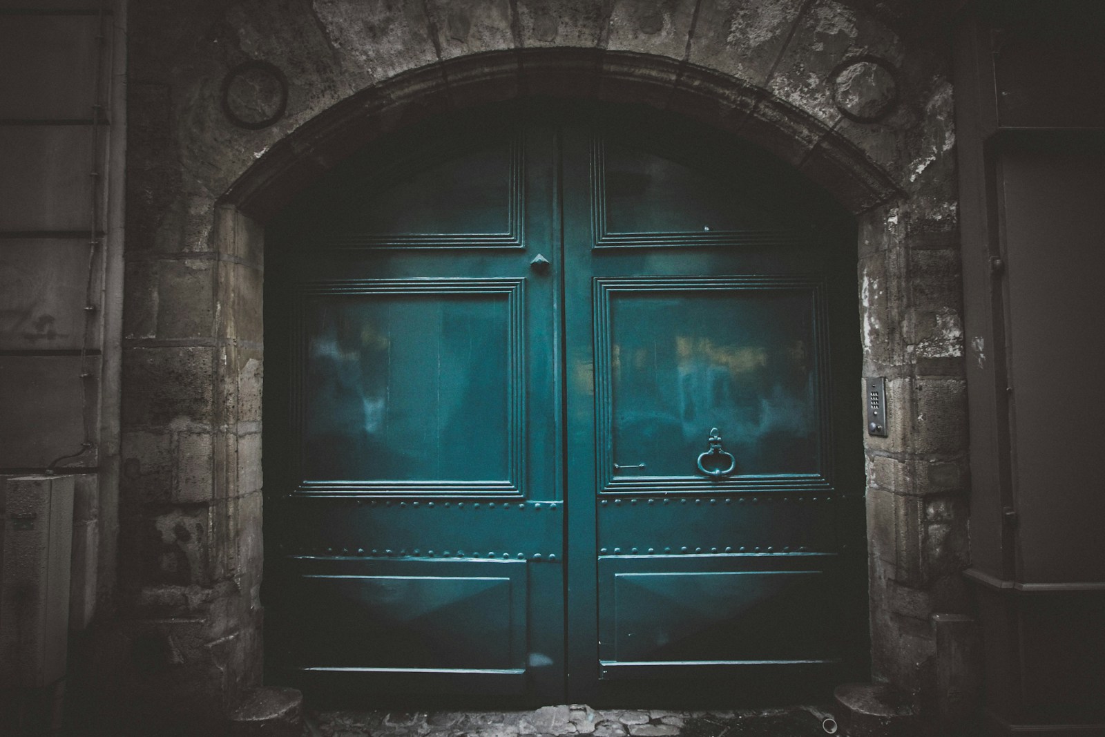 Photo by Jeremy Bishop blue wooden double arch door s
