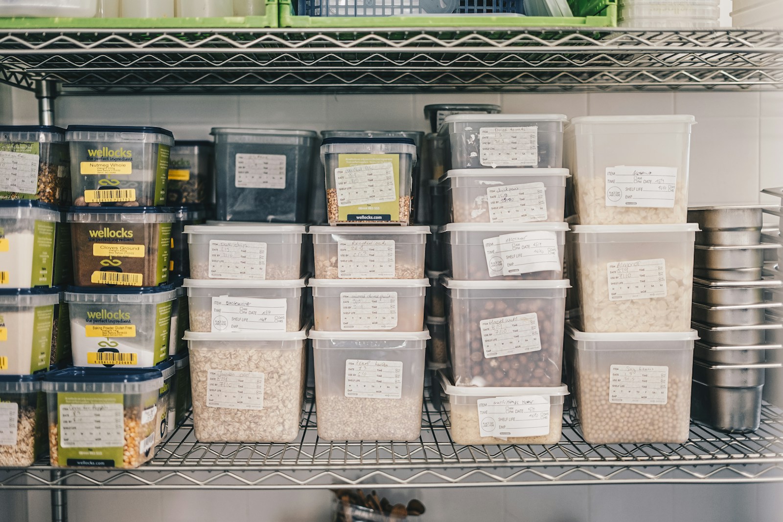 Photo by Ambitious Studio* | Rick Barrett a shelf filled with containers and containers of food