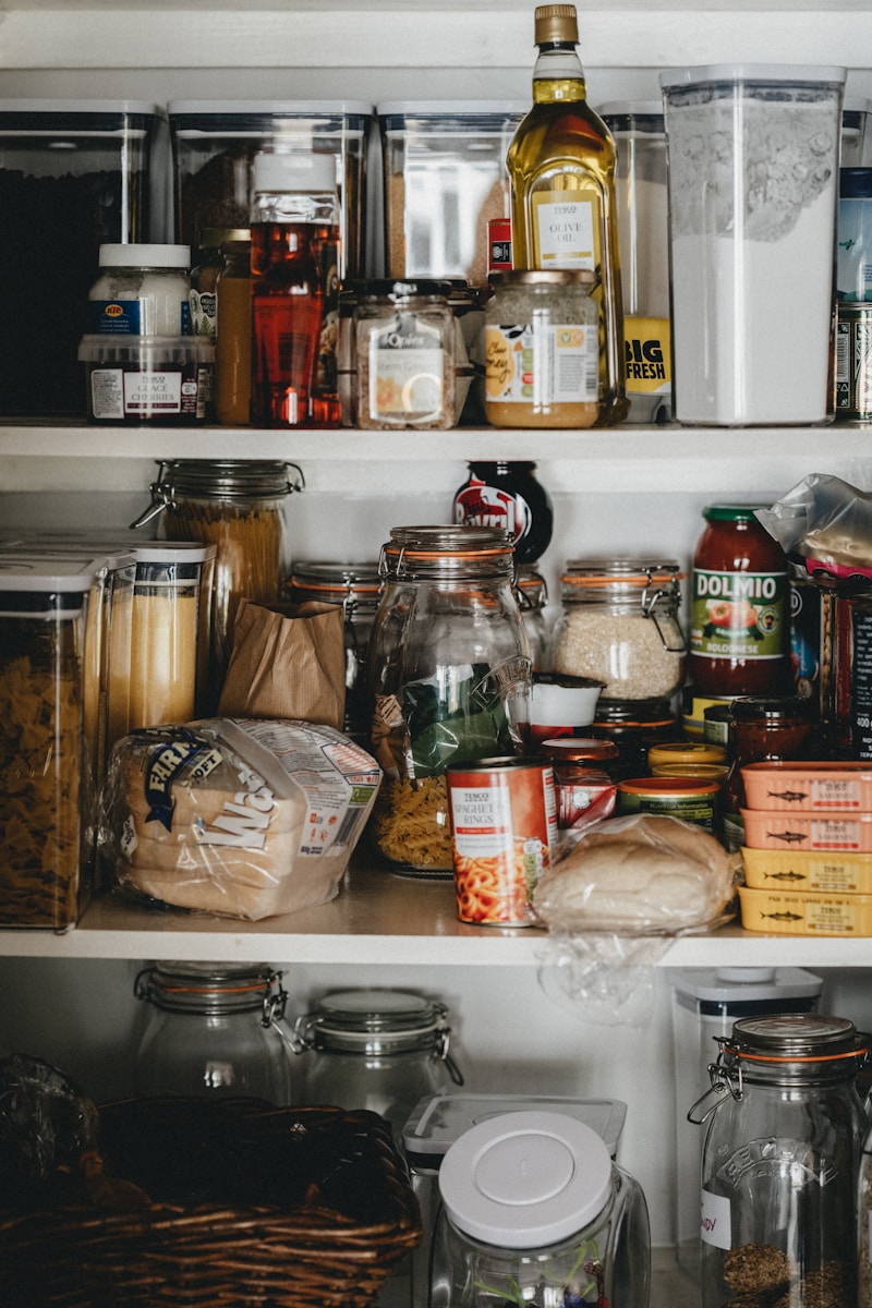 Photo by Annie Spratt clear glass jars on white shelf