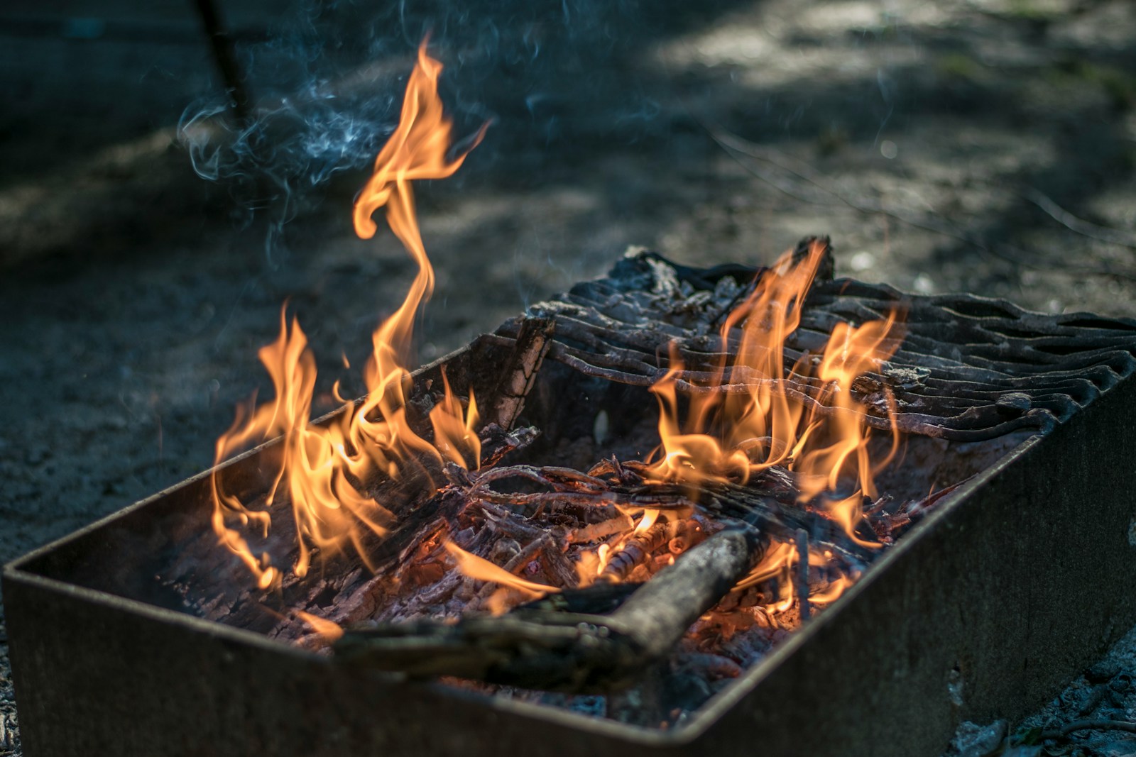 Photo by Alan Labisch rectangular black fire pit with fire at daytime