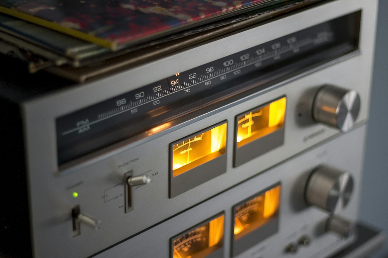 Photo by Pixabay Close-up of retro audio equipment featuring illuminated dials and radio tuner.