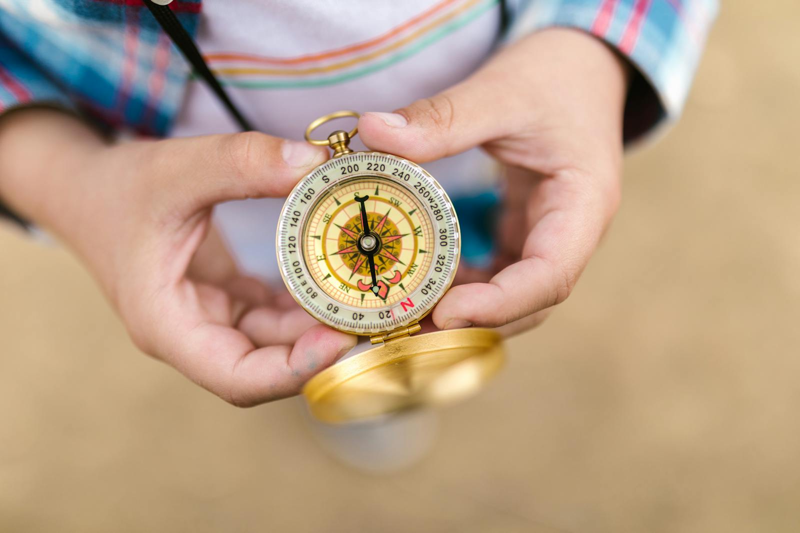 Photo by RDNE Stock project A detailed view of hands holding a vintage compass, suggesting exploration and guidance.