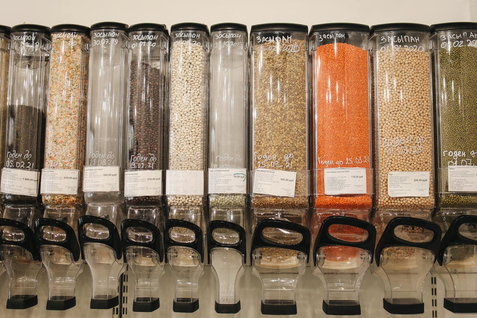 Photo by Polina Tankilevitch Row of eco-friendly bulk food dispensers in a shop promoting zero waste shopping.