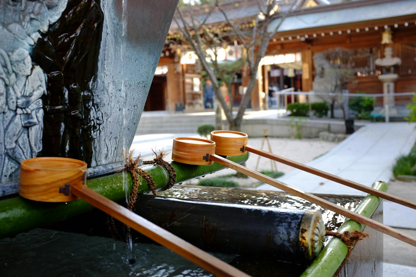 Photo by AKANE ZEN Explore a serene water basin at a traditional Japanese shrine in Fukuoka.