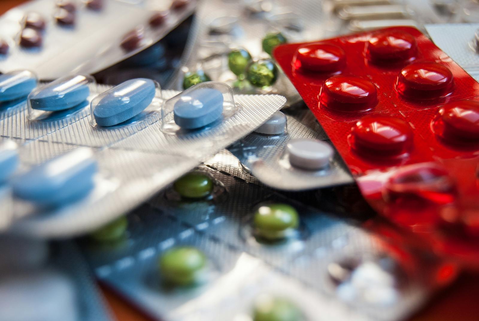 Photo by Diamond Rehab Thailand Close-up of various colored medication pills in blister packs.